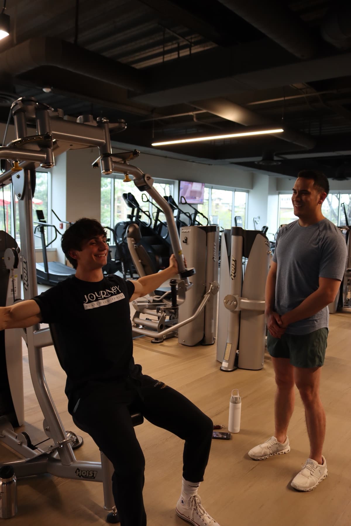 Kris Oddo smiling with a client during a gym training session