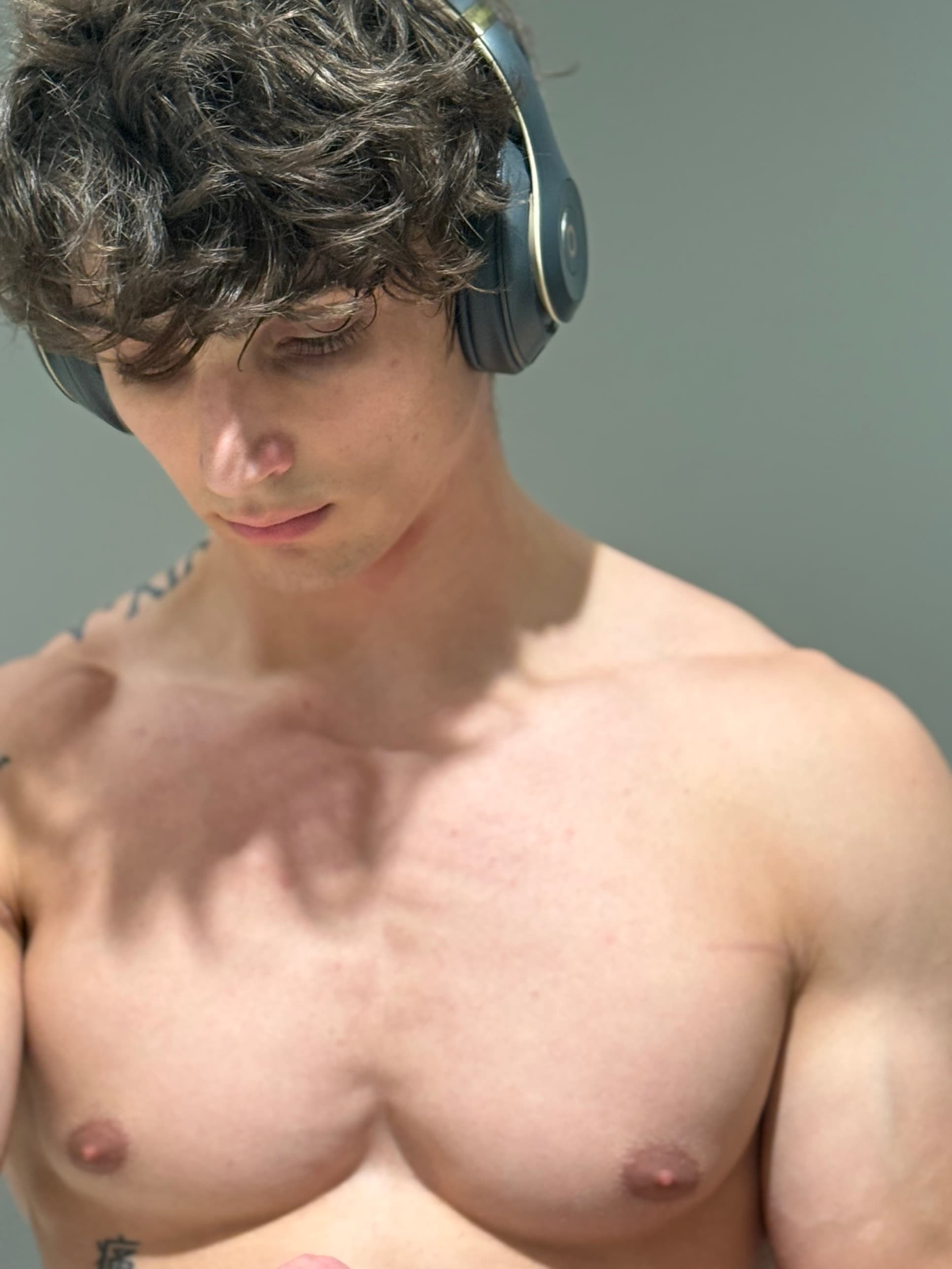 Kris Oddo, NASM-CPT, online fitness coach, in headphones