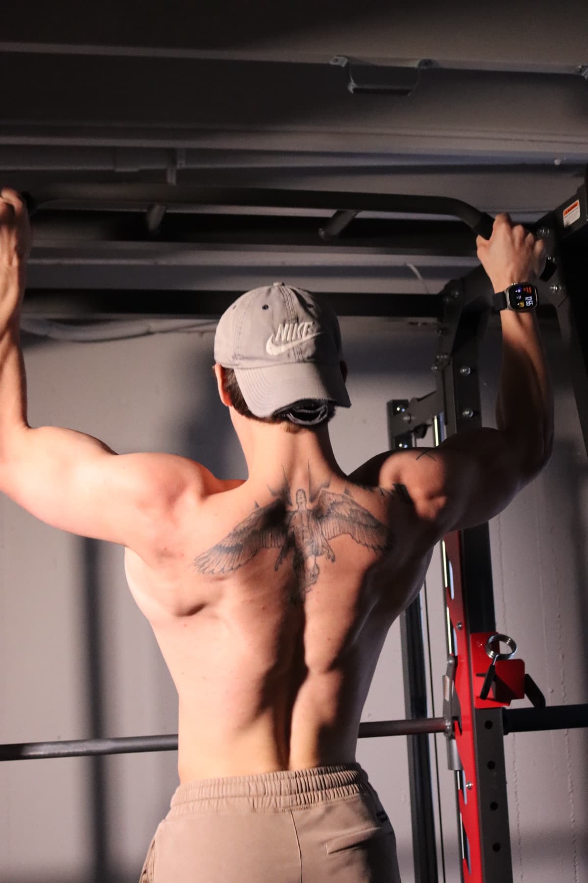 Kris Oddo showing back development during a gym training session